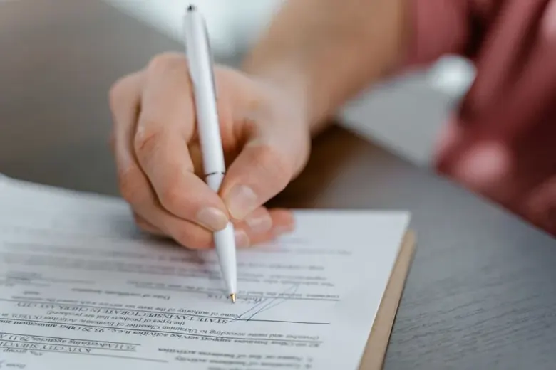 Person signing a legal agreement